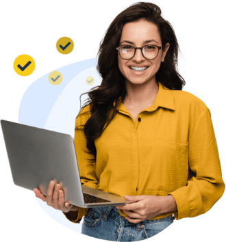 Woman standing with a laptop and smiling at the camera